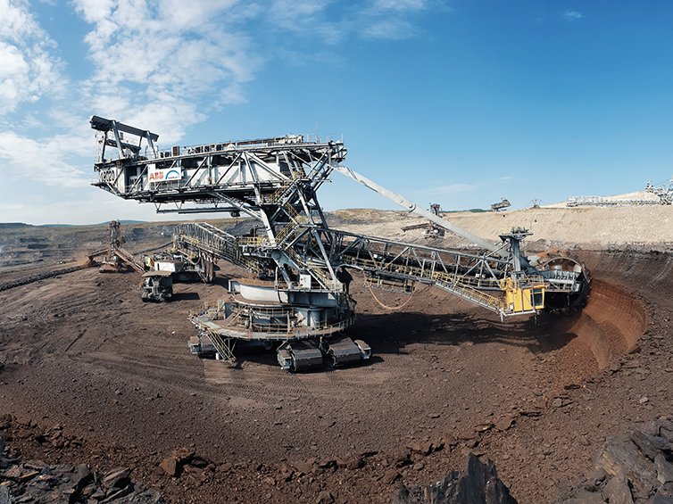 What are the key technologies and equipment used in surface mining, and how have they evolved over time?
